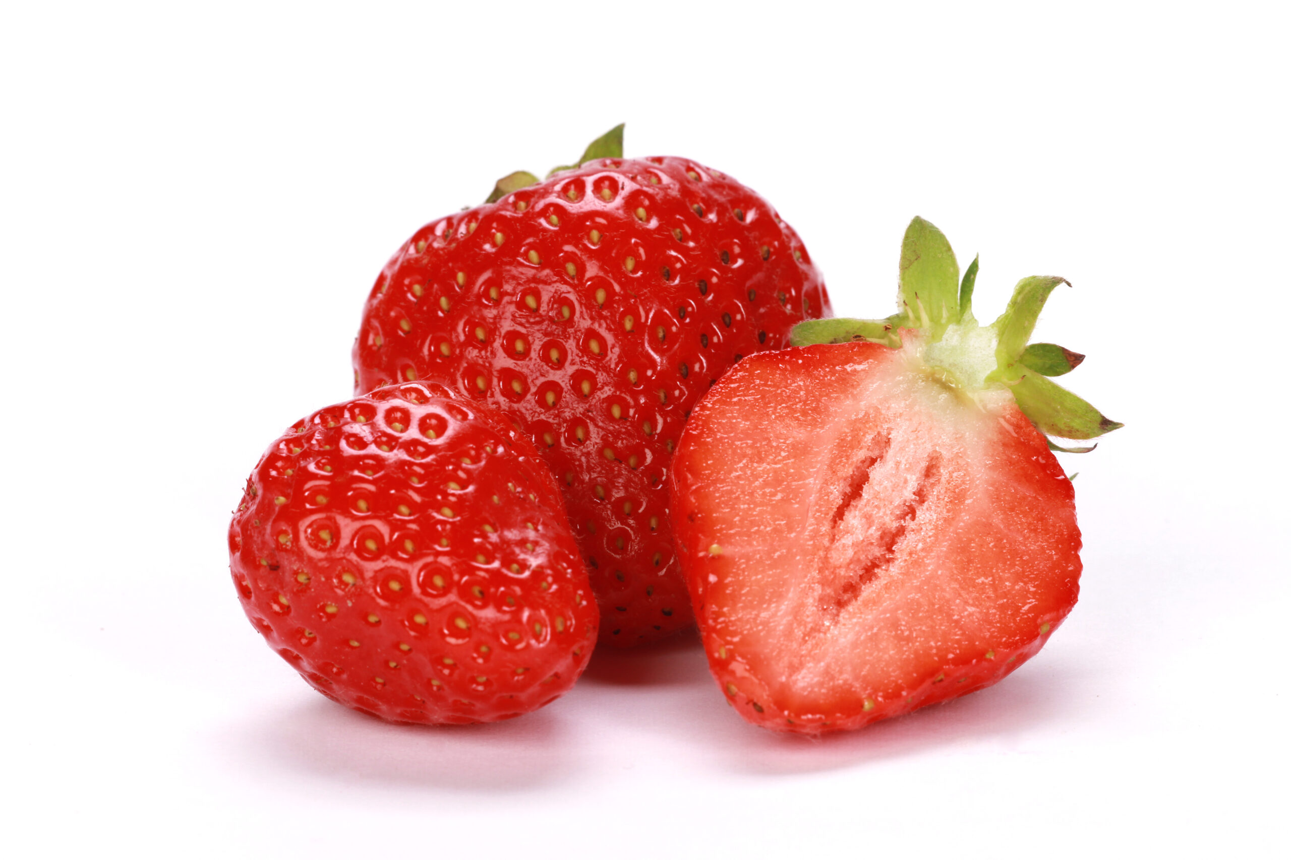 A closeup shot of fresh ripe strawberries  isolated on a white background